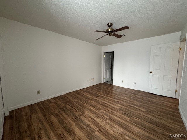 unfurnished bedroom featuring dark wood-style floors, ceiling fan, a textured ceiling, and baseboards