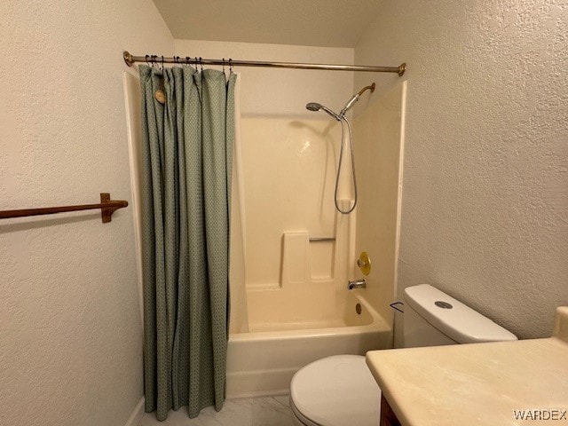 bathroom with toilet, shower / bathtub combination with curtain, vanity, and a textured wall