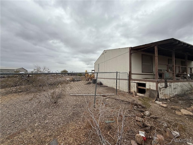 view of side of property with an outbuilding and fence