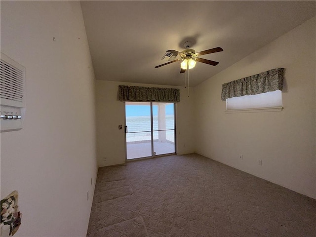 2217 E Emerald River Way, Fort Mohave, AZ 86426 - spare room with lofted ceiling, ceiling fan, and carpet flooring