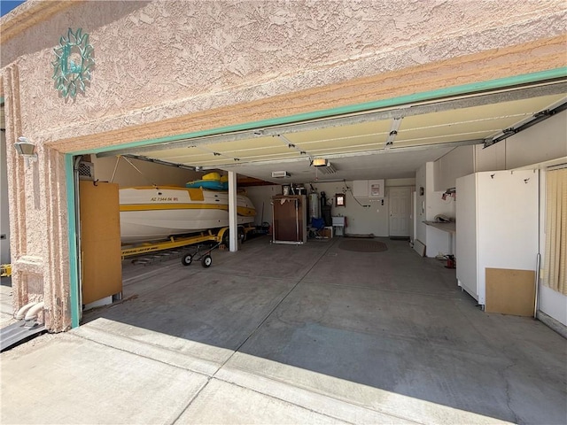 2217 E Emerald River Way, Fort Mohave, AZ 86426 - garage with a garage door opener and electric water heater