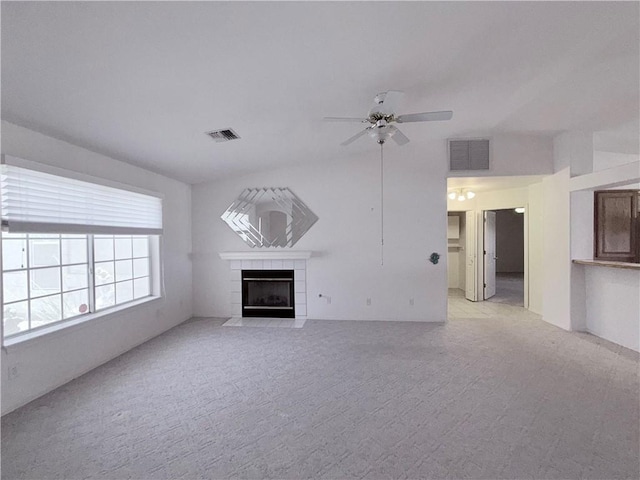 2217 E Emerald River Way, Fort Mohave, AZ 86426 - unfurnished living room featuring a fireplace, light carpet, and ceiling fan