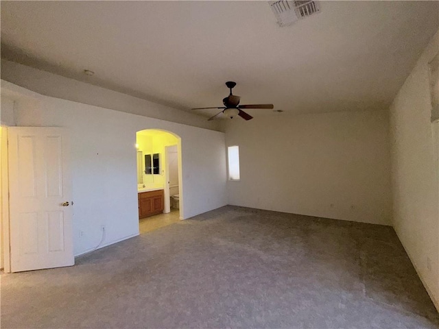 2217 E Emerald River Way, Fort Mohave, AZ 86426 - empty room with ceiling fan, light colored carpet, and arched walkways