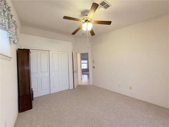 2217 E Emerald River Way, Fort Mohave, AZ 86426 - unfurnished bedroom featuring light colored carpet, a ceiling fan, and a closet