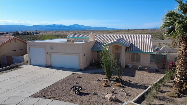 2217 E Emerald River Way, Fort Mohave, AZ 86426 - view of front of property with a garage, stucco siding, driveway, and a mountain view