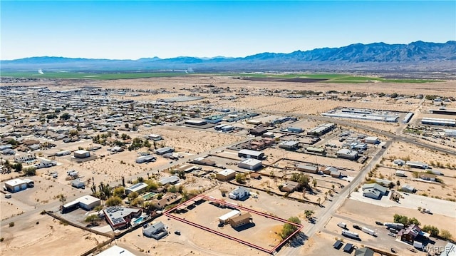 bird's eye view with a desert view and a mountain view