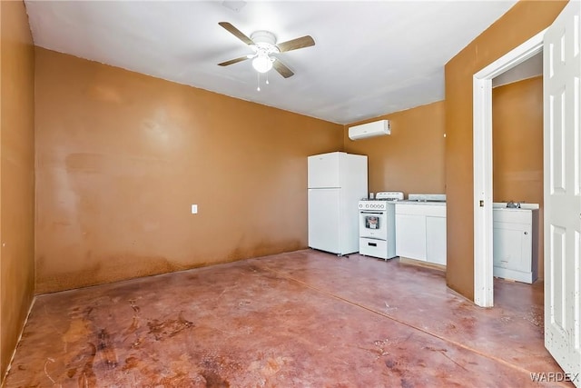 interior space featuring a wall unit AC, white cabinets, ceiling fan, white appliances, and concrete floors