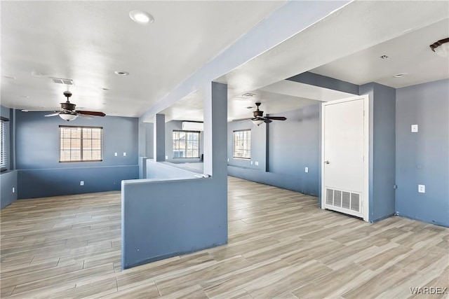 interior space featuring light wood finished floors, visible vents, and a ceiling fan