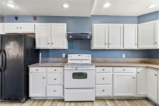 kitchen featuring freestanding refrigerator, white cabinets, under cabinet range hood, and white electric range oven