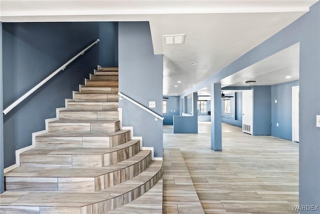 stairway featuring a ceiling fan, wood tiled floor, visible vents, and recessed lighting