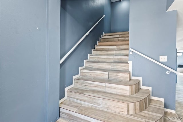 staircase featuring baseboards