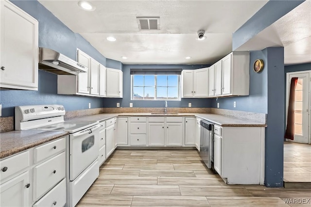 kitchen with white electric range oven, visible vents, a sink, wall chimney range hood, and dishwasher