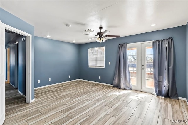 unfurnished room featuring wood tiled floor, french doors, and baseboards