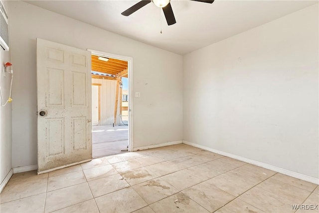 unfurnished room featuring ceiling fan and baseboards