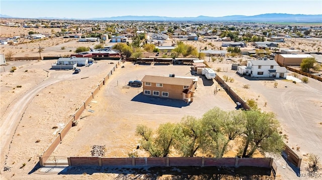 birds eye view of property featuring a residential view, view of desert, and a mountain view