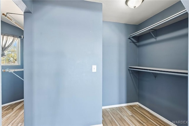 walk in closet featuring wood finished floors