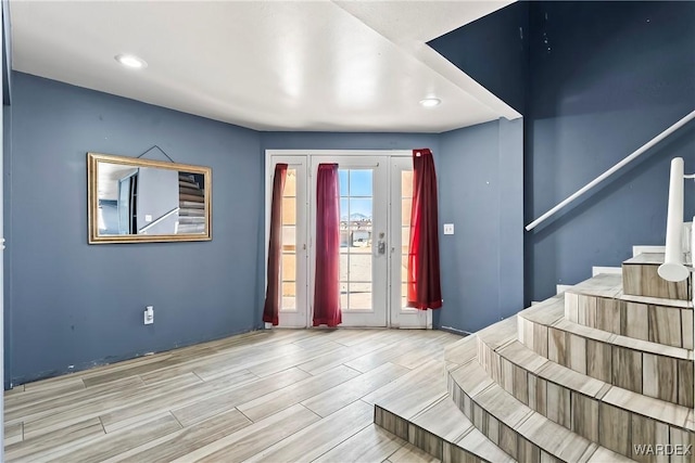 foyer entrance featuring wood tiled floor, stairs, and recessed lighting