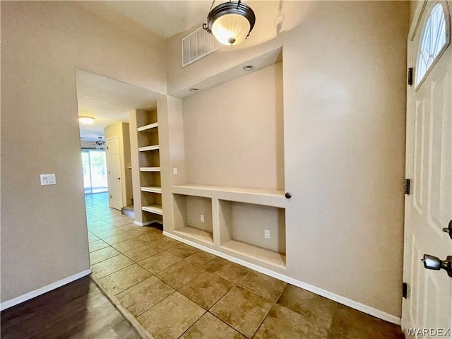 mudroom featuring baseboards, visible vents, and built in features