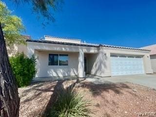 ranch-style house with driveway and an attached garage