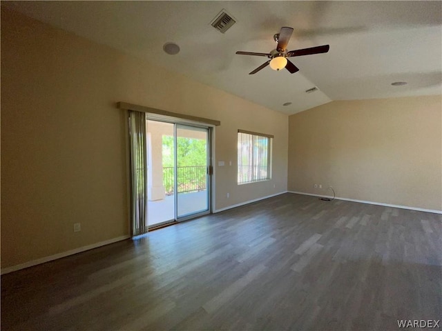 empty room featuring lofted ceiling, ceiling fan, visible vents, baseboards, and dark wood finished floors