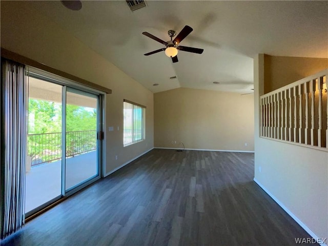 empty room with baseboards, visible vents, a ceiling fan, dark wood-type flooring, and vaulted ceiling