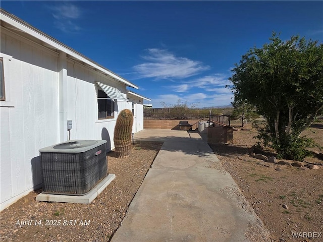 view of yard featuring a patio area and central air condition unit