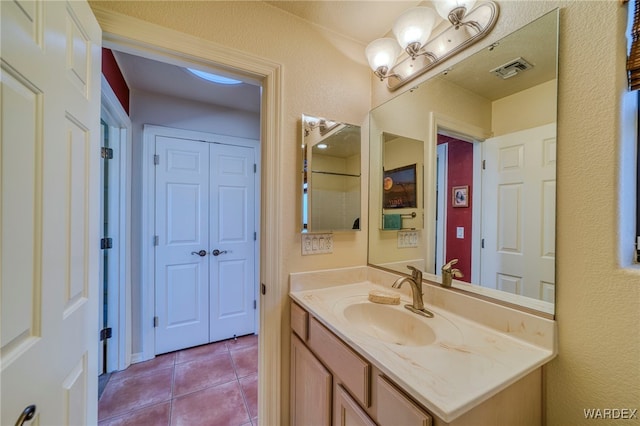 bathroom with visible vents, vanity, and tile patterned floors