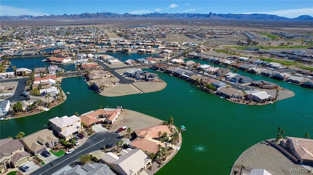 drone / aerial view with a residential view and a water and mountain view