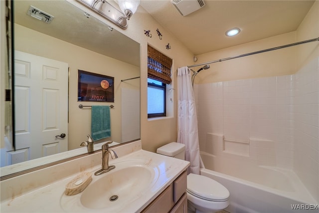 full bathroom featuring shower / tub combo, visible vents, vanity, and toilet