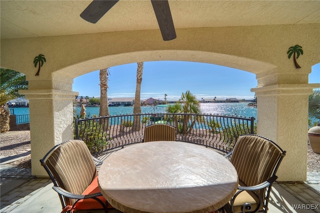 view of patio / terrace with a water view and a balcony