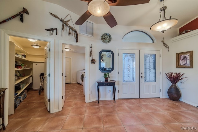 foyer featuring light tile patterned floors, visible vents, a ceiling fan, baseboards, and french doors