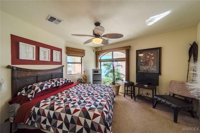 bedroom with a ceiling fan, visible vents, and carpet flooring