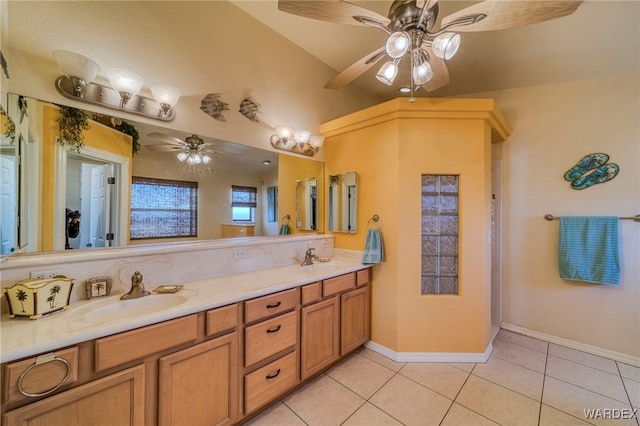 bathroom with double vanity, baseboards, a ceiling fan, tile patterned floors, and a sink