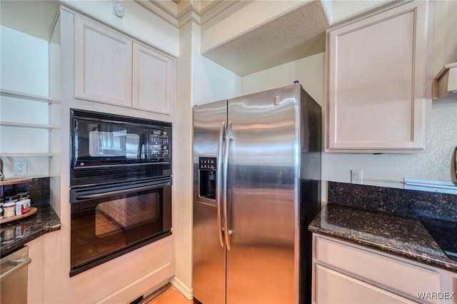 kitchen with dark stone countertops, white cabinets, and black appliances