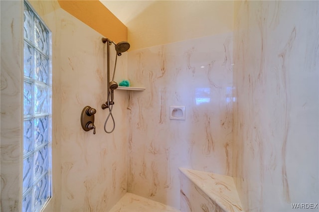 full bathroom with a marble finish shower