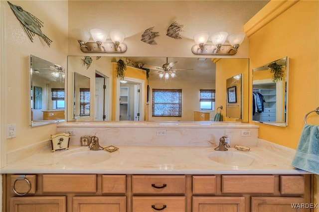 bathroom featuring double vanity, a sink, and a ceiling fan