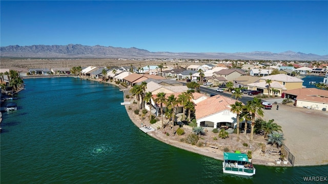 birds eye view of property featuring a water and mountain view and a residential view