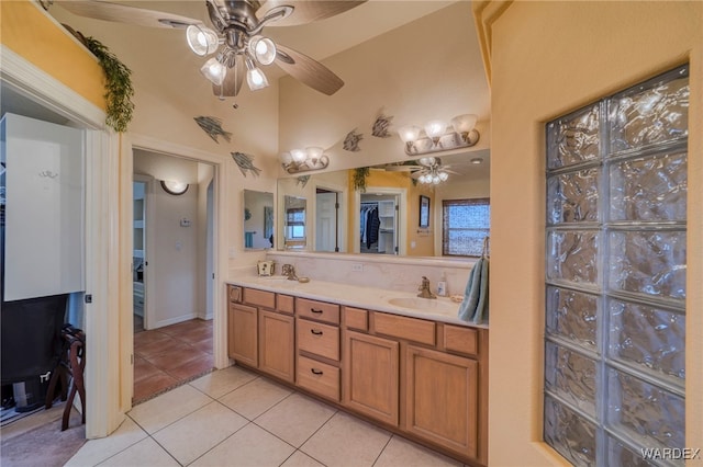 full bath with double vanity, tile patterned flooring, a ceiling fan, and a sink