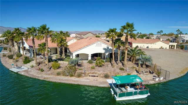 rear view of property with a residential view, a water view, and stucco siding