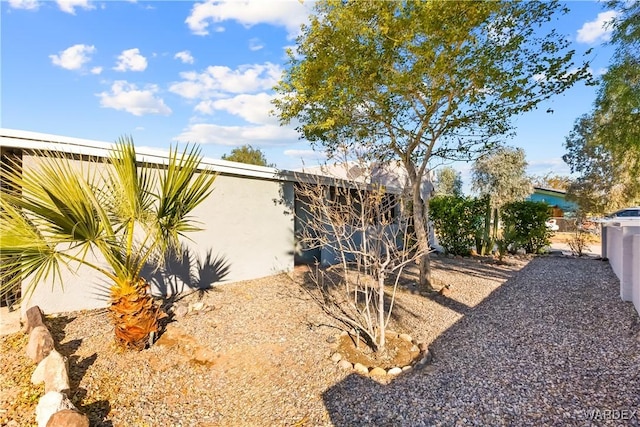 exterior space featuring fence and stucco siding