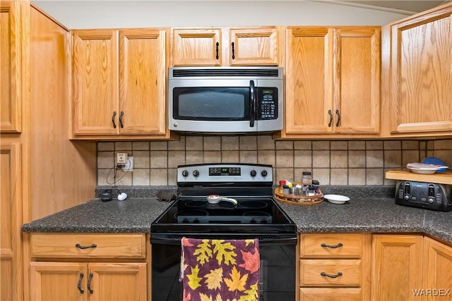 kitchen featuring dark countertops, stainless steel microwave, backsplash, and black / electric stove