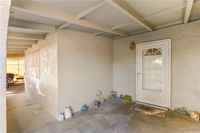 doorway to property with a patio area and stucco siding