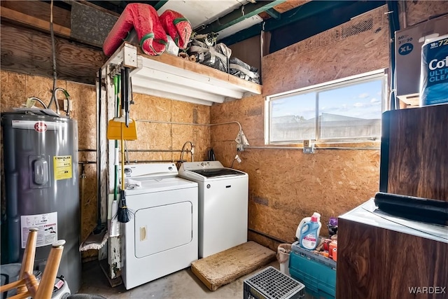 washroom featuring laundry area, electric water heater, and washer and clothes dryer