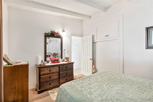 bedroom featuring beamed ceiling and light colored carpet