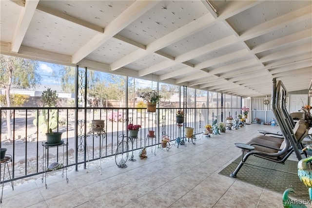 gym featuring coffered ceiling and a wall of windows