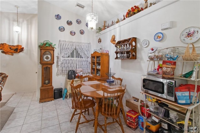 dining room featuring light tile patterned floors and visible vents