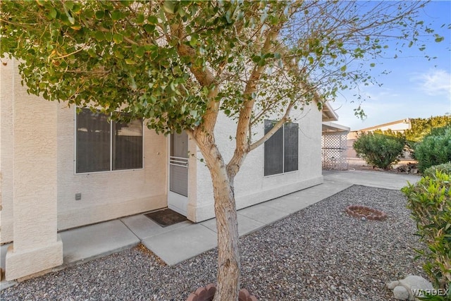 back of property featuring a patio area and stucco siding