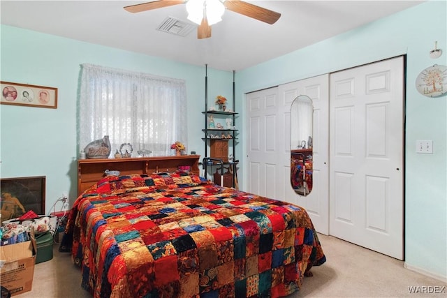 bedroom featuring a closet, visible vents, ceiling fan, and light carpet