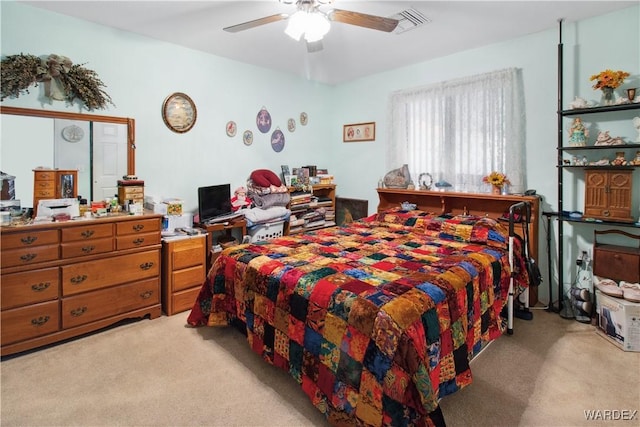 bedroom featuring a ceiling fan, light carpet, and visible vents