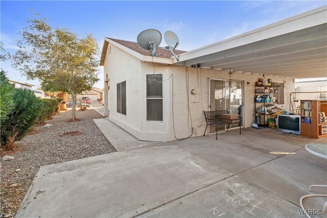 back of house featuring a patio area and stucco siding